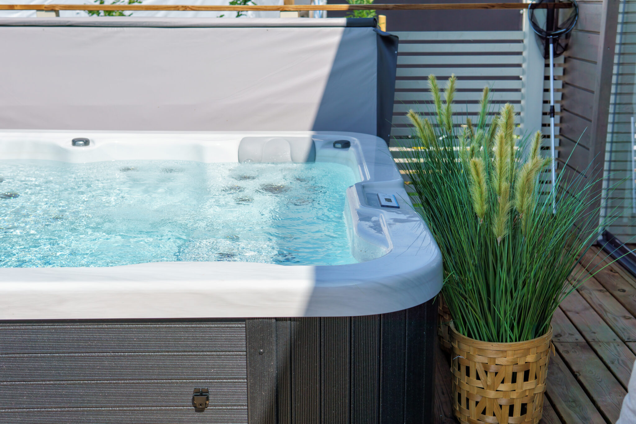 An image of a swim spa on a back patio.